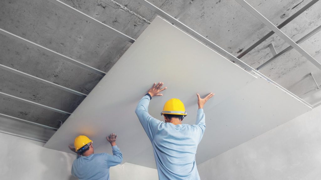 Gypsum board being installed for soundproofing